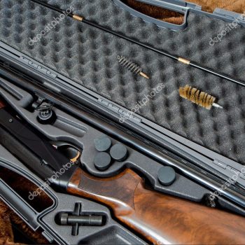 a disassembled 12 gauge hunting shotgun and cleaning kit in a gray gun case Firearms & Parts learn more >