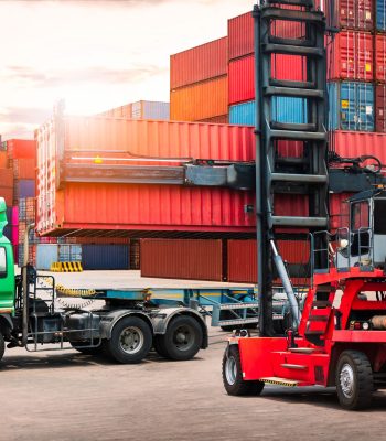 Shipping Container being loaded onto transport truck at depot – sea cargo clearance concept Other Freight Forwarders